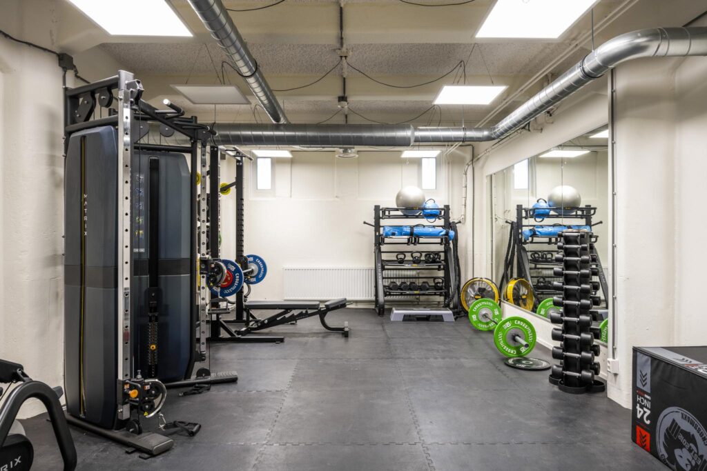 Modern gym space on Van Diemenstraat with weightlifting equipment, dumbbells, and functional training tools.
